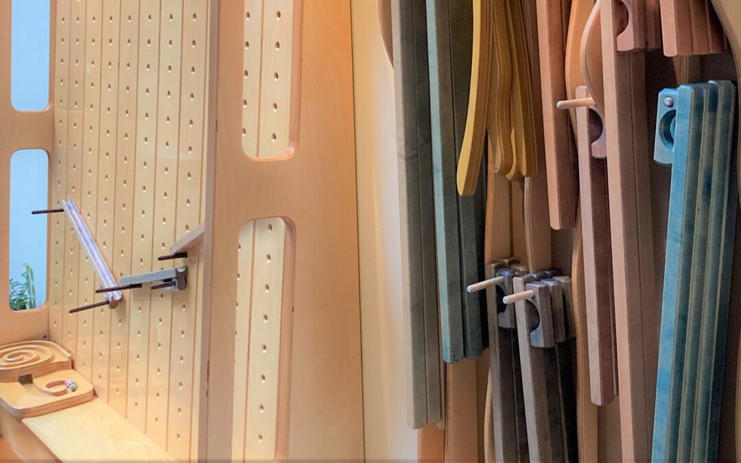 Detail of Rollentless' handcrafted pegboard and various marble tracks